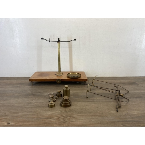 1322 - Three items, one Victor British made brass weighing scales on mahogany plinth with weights, one Vict... 