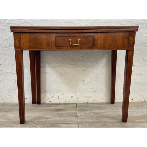 1119 - A George III inlaid mahogany fold over tea table - approx. 74cm high x 89cm wide x 45cm deep not ext... 