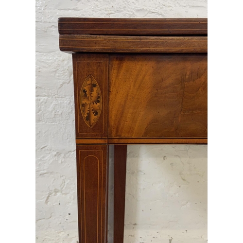 1119 - A George III inlaid mahogany fold over tea table - approx. 74cm high x 89cm wide x 45cm deep not ext... 