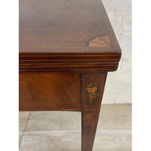 1119 - A George III inlaid mahogany fold over tea table - approx. 74cm high x 89cm wide x 45cm deep not ext... 