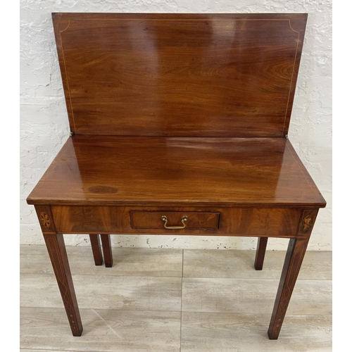 1119 - A George III inlaid mahogany fold over tea table - approx. 74cm high x 89cm wide x 45cm deep not ext... 