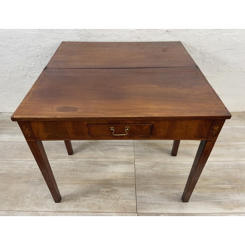 1119 - A George III inlaid mahogany fold over tea table - approx. 74cm high x 89cm wide x 45cm deep not ext... 