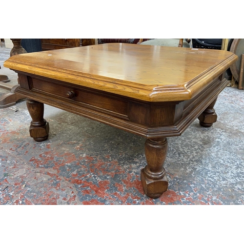 1123 - An oak coffee table - approx. 49cm high x 97cm wide x 97cm deep