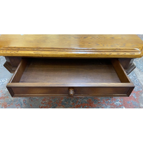 1123 - An oak coffee table - approx. 49cm high x 97cm wide x 97cm deep