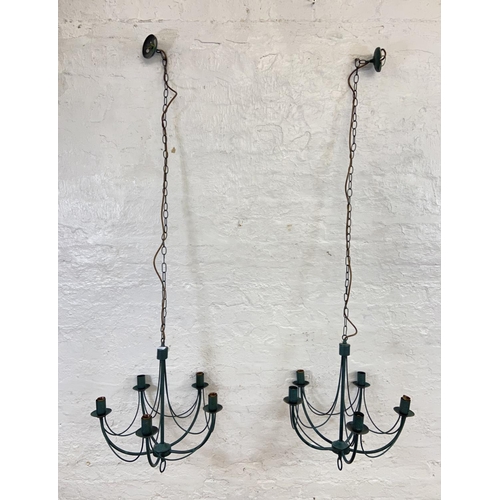 1126 - Three green painted wrought metal chandeliers