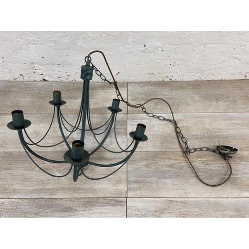 1126 - Three green painted wrought metal chandeliers