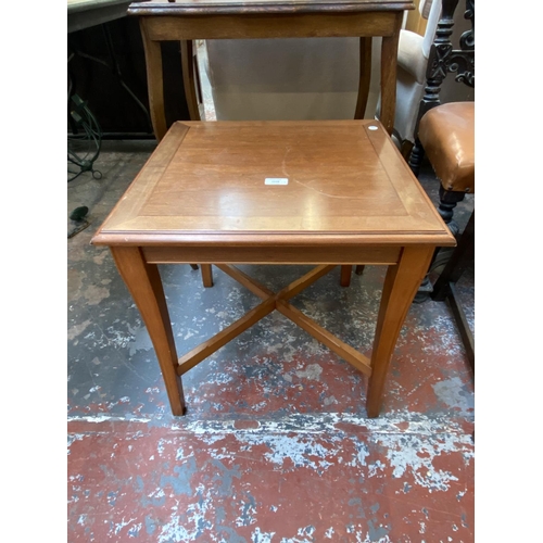 1128 - Three pieces of furniture, one Edwardian oak serpentine two tier side table, one cherrywood side tab... 