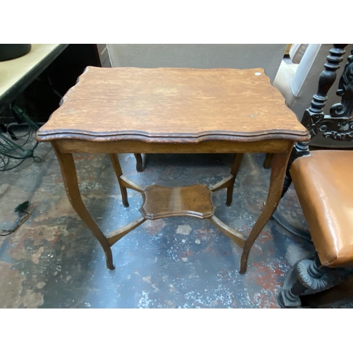 1128 - Three pieces of furniture, one Edwardian oak serpentine two tier side table, one cherrywood side tab... 