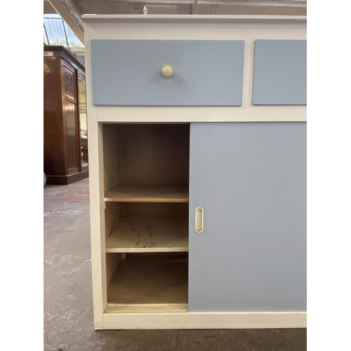 1135C - A mid 20th century blue and white painted kitchen cabinet with laminate top - approx. 85cm high x 84... 