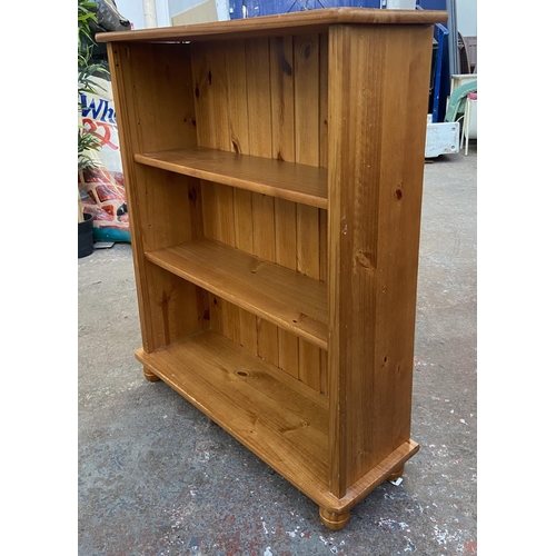 1149 - A modern pine three tier bookcase - approx. 100cm high x 84cm wide x 28cm deep