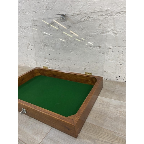 1153 - A stained hardwood table top display case with acrylic top and green felt interior - approx. 8cm hig... 