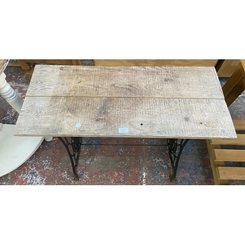 1157 - A late 19th/early 20th century Singer cast iron sewing machine table base with later added pine top ... 