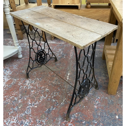 1157 - A late 19th/early 20th century Singer cast iron sewing machine table base with later added pine top ... 