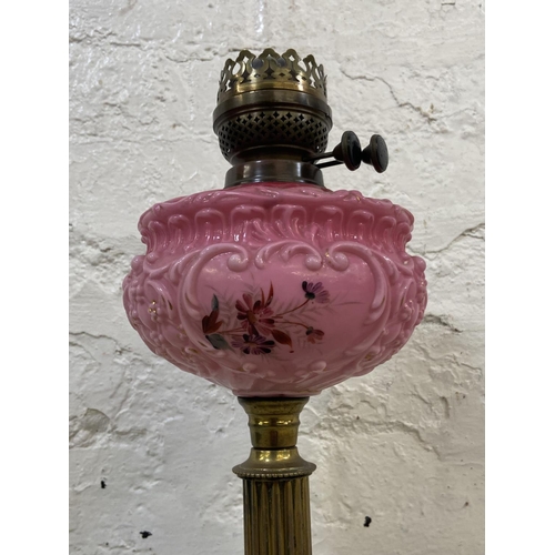 1158 - A Victorian Duplex brass oil lamp with hand painted pink glass reservoir, etched glass shade and cle... 