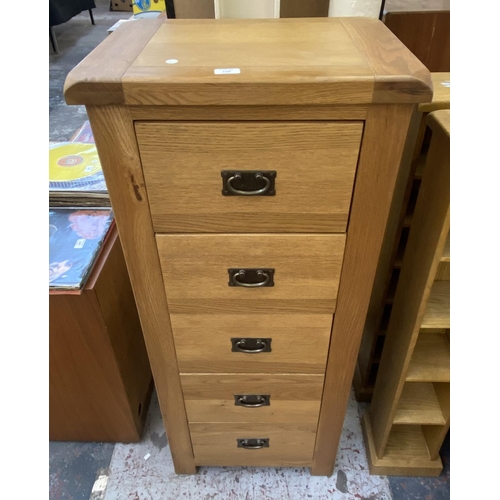 1162 - A modern oak chest of drawers - approx. 130cm high x 55cm wide x 40cm deep