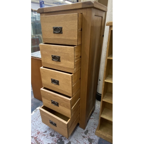 1162 - A modern oak chest of drawers - approx. 130cm high x 55cm wide x 40cm deep