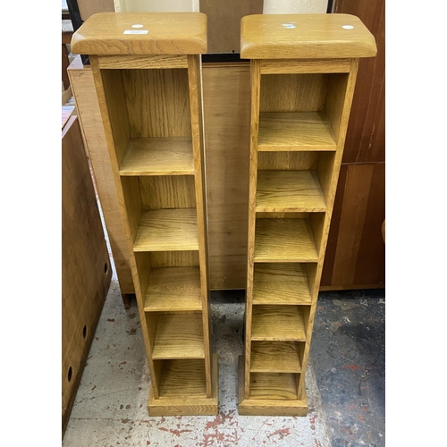 1163 - Two modern oak CD racks - approx. 116cm high x 22cm wide x 18cm deep