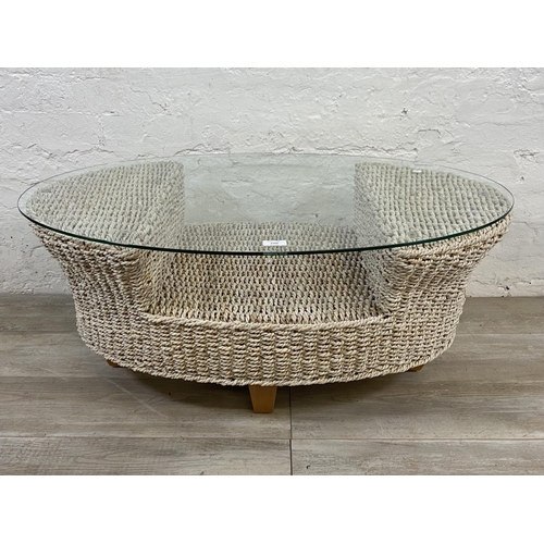 1166 - A modern wicker and glass top coffee table - approx. 42cm high x 61cm wide x 96cm long