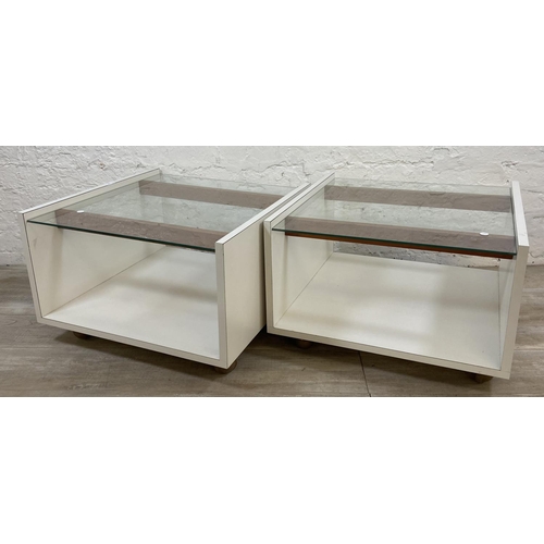 1168 - A pair of mid 20th century white laminate and glass top side tables - approx. 40cm high x 62cm wide ... 