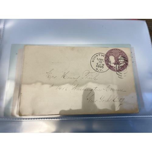 1407 - An album containing 19th century and later United States stamped postal envelopes and First Day Cove... 