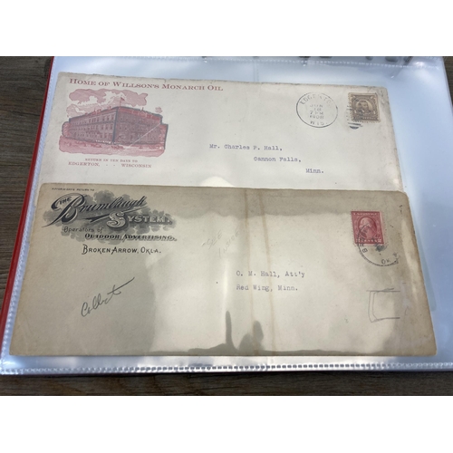 1407 - An album containing 19th century and later United States stamped postal envelopes and First Day Cove... 