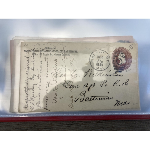 1407 - An album containing 19th century and later United States stamped postal envelopes and First Day Cove... 