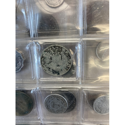 1408 - A coin album containing world coins to include silver examples