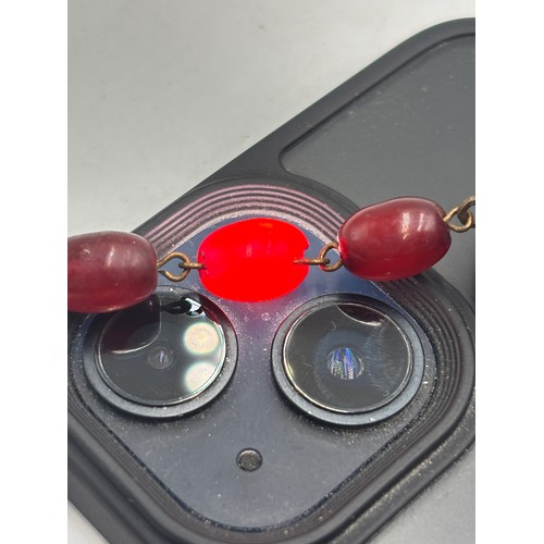 2110 - A cherry Bakelite beaded necklace with internal streaking - approx. gross weight 23.6g