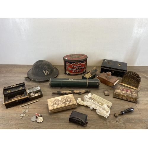 1414 - A collection of items to include WWII British Civil Defence warden's helmet, late 19th century brass... 