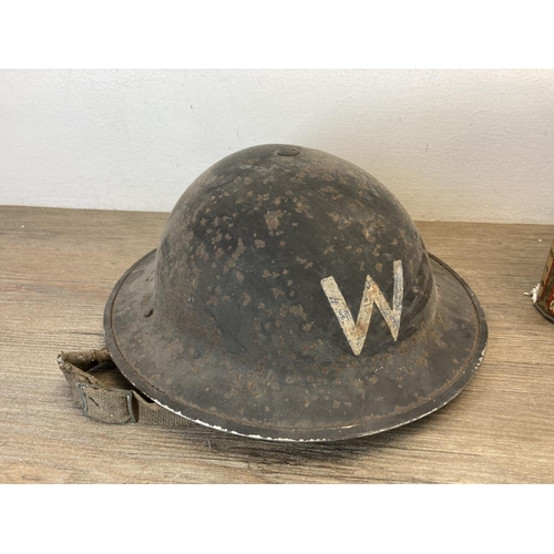 1414 - A collection of items to include WWII British Civil Defence warden's helmet, late 19th century brass... 