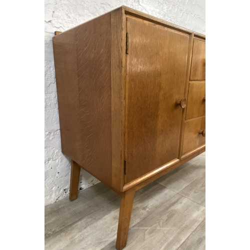 1176 - A mid 20th century Meredew oak sideboard - approx. 85cm high x 114cm wide x 47cm deep