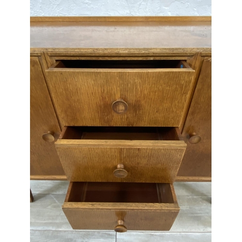 1176 - A mid 20th century Meredew oak sideboard - approx. 85cm high x 114cm wide x 47cm deep