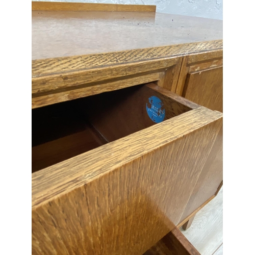 1176 - A mid 20th century Meredew oak sideboard - approx. 85cm high x 114cm wide x 47cm deep