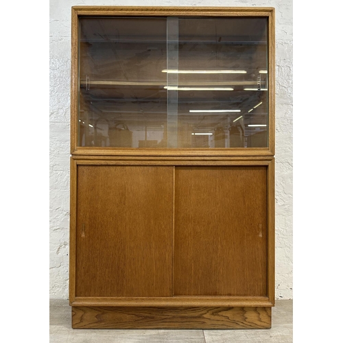 1184 - A mid 20th century oak bookcase with two glass sliding doors - approx. 122cm high x 76cm wide x 26cm... 