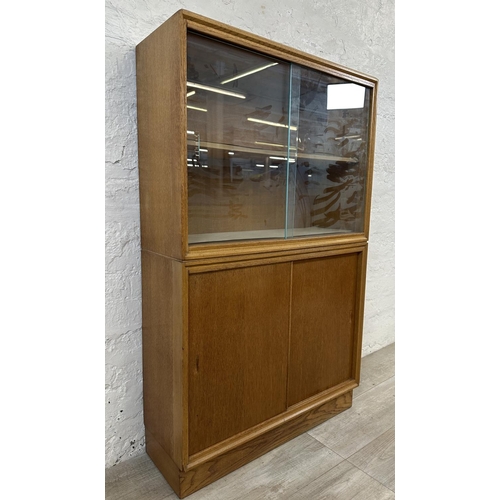 1184 - A mid 20th century oak bookcase with two glass sliding doors - approx. 122cm high x 76cm wide x 26cm... 