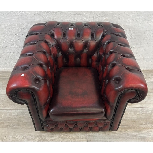 1188 - An oxblood leather Chesterfield club chair - approx. 80cm high x 100cm wide x 86cm deep