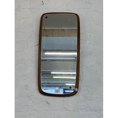 1196 - A mid 20th century teak framed wall mirror - approx. 73cm x 35cm