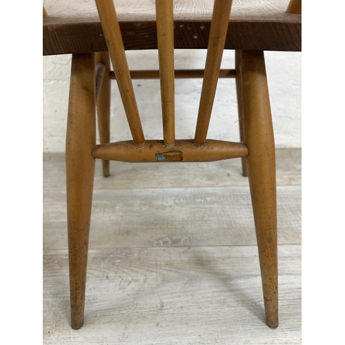 1200 - A mid 20th century Ercol model 384 blonde elm and beech Windsor drop leaf dining table and four mode... 