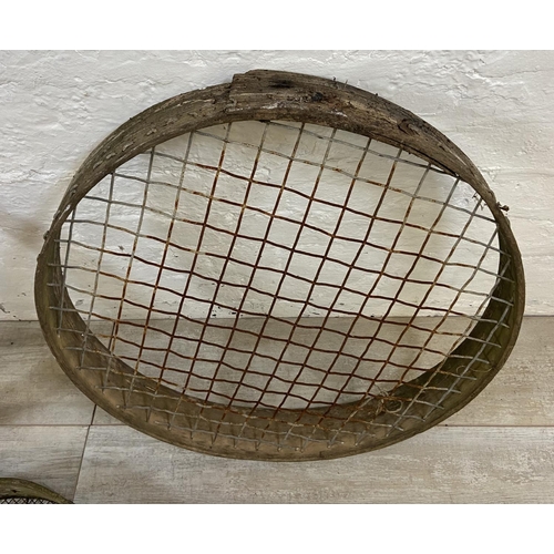 1203 - Three vintage wood and wired metal sieves