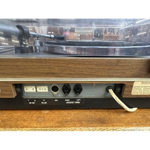 1507 - A vintage Sharp SG-315E music centre comprising two-speed turntable, cassette player, four-band rece... 