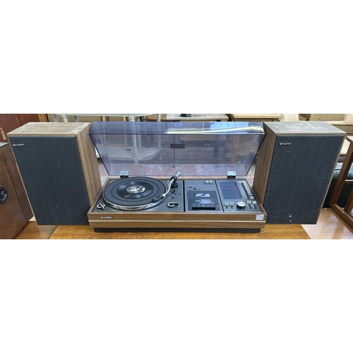 1507 - A vintage Sharp SG-315E music centre comprising two-speed turntable, cassette player, four-band rece... 