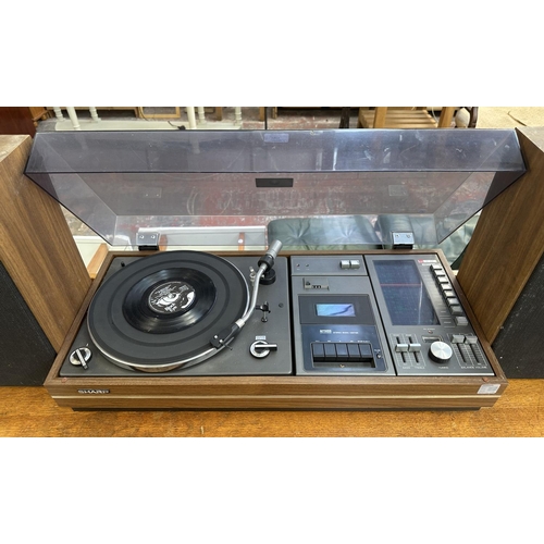 1507 - A vintage Sharp SG-315E music centre comprising two-speed turntable, cassette player, four-band rece... 