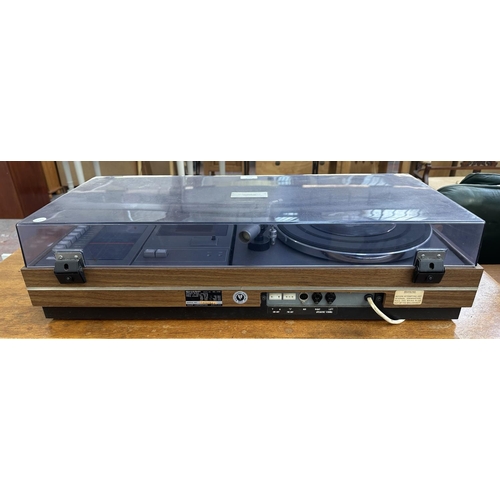 1507 - A vintage Sharp SG-315E music centre comprising two-speed turntable, cassette player, four-band rece... 