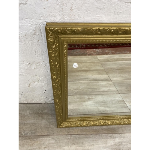 1212 - A modern gilt framed rectangular over mantel wall mirror - approx. 61cm high x 83cm wide