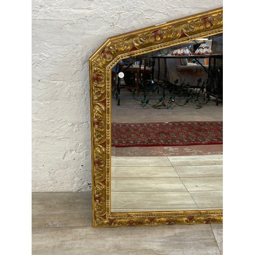 1244 - A modern gilt framed decorative bevelled edge overmantle wall mirror - approx. 90cm high x 107cm wid... 