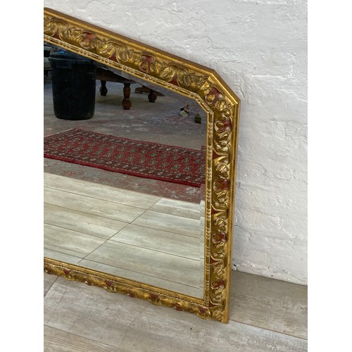 1244 - A modern gilt framed decorative bevelled edge overmantle wall mirror - approx. 90cm high x 107cm wid... 