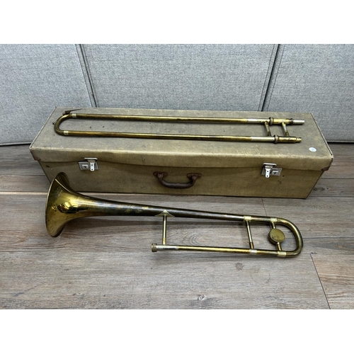 1515 - A cased Besson Stratford trombone with two mouth pieces to include one John Grey