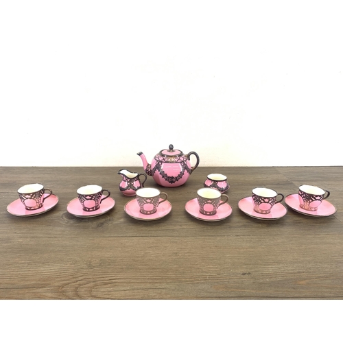 1265 - An early 20th century The Paragon China pink glazed ceramic fifteen piece coffee set with white meta... 