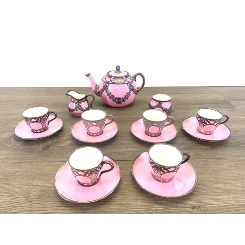 1265 - An early 20th century The Paragon China pink glazed ceramic fifteen piece coffee set with white meta... 