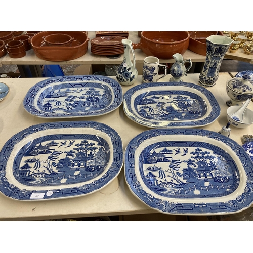 404 - Twenty three pieces of blue and white ceramics to include four Willow pattern meat plates, Delftware... 